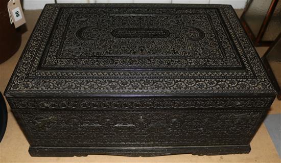 Early 20C Indian ebony presentation stationery box, all over carved with floral and foliate scrolls, fitted interior
